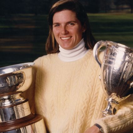 Sarah Ingram holding two large trophies
