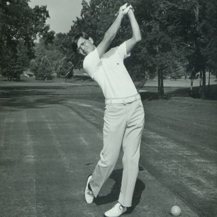 Willie Gibbons swinging a golf club at the tee box.